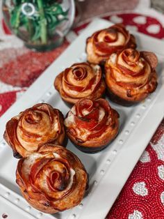 several pastries are sitting on a white plate with red and white tablecloths