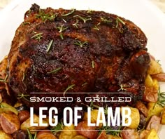 a large piece of meat on top of potatoes and carrots with the words smoked & grilled leg of lamb