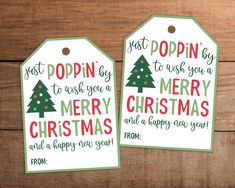 two christmas gift tags with the words just popin'to wish you a merry christmas and a happy new year