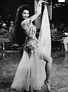 an old photo of a woman in a belly dance costume