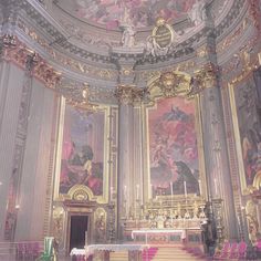 the interior of a church with ornate paintings on the walls