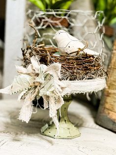 a bird nest with two white birds in it