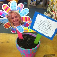 a child's photo is placed in a flower pot with a sign attached to it