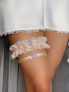 Delicate tulle wedding garter set in cute blush pink color is decorated with lovely embroidered flower lace, and handmade accent blue 3D flower, manually jeweled with pearl beads. A delicate and even a bit naive bridal garter will definitely add that extra special touch to your Wedding Day! The whimsical tulle garter for bride will also serve as amazing something blue detail! And soft stretchy toss garter will match the set to brighten up your Special look! Choose the preferable amount of thigh Tulle Garter, Garter For Wedding, Leg Garters, Blush Pink Wedding, Wedding Garter Set, Blush Pink Weddings, Bridal Garter, Wedding Garter, Garter Set