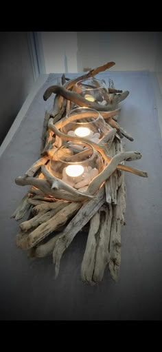 driftwood candle holder with candles in it