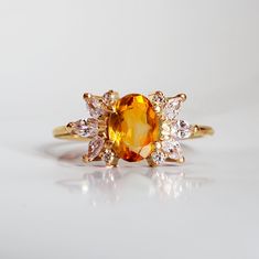 Enjoy the beauty of the Citrine Sunburst ring right at your fingertips. Like a burst of sun rays, this ring features a natural oval citrine surrounded by sparkly white CZs. Handcrafted in your choice of gold vermeil, and 14K solid gold. Gold vermeil or 14K gold 7x5mm natural oval Citrine Round and marquise CZs 1.2mm ring band **This item is specially made for you. Please allow 1-2 week lead time. ShippingDomestic: Free standard shipping within the U.S.International: Free standard shipping for or Orange Rings Engagement, Citrine Gold Ring, Orange Engagement Ring, Citrine Rings, Citrine Engagement Ring, Citrine Wedding, Secret Secret, Sunburst Ring, Citrine Ring Engagement