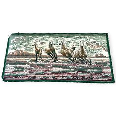 three horses running in the water on a rug