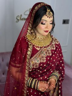 a woman wearing a red bridal outfit