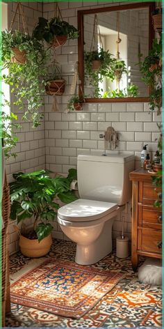 a white toilet sitting in a bathroom next to a plant filled wall mounted above it