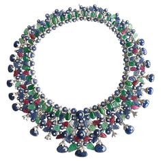 This Emerald, Ruby & Sapphire Necklace with Diamonds in 18k White Gold is a stunning piece of jewelry that features exquisite gemstones arranged in the shape of a leaf. The emerald, ruby, and sapphire are intricately carved to add texture and depth to the design, giving it a unique and artistic appeal. The diamonds add a touch of sparkle and elegance, while the 18k white gold setting adds to the luxurious look and feel of the necklace. Overall, this necklace creates the sensation of a beautiful Ruby And Sapphire, Necklace With Diamonds, White Gold Set, Vintage Necklaces, Ruby Sapphire, Sapphire Necklace, Gems Jewelry, Multi Strand Necklace, Crystal Gems