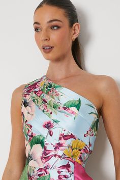 a woman in a floral one shoulder dress