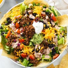 a bowl filled with taco salad and tortilla chips