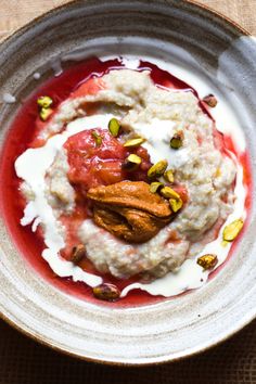 a bowl filled with oatmeal and nuts on top of a table