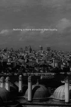 black and white photograph of rooftops with city in the background