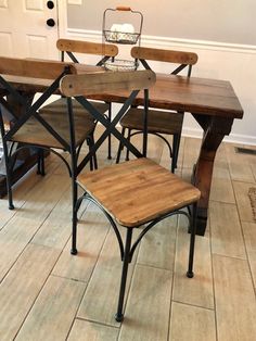 four wooden chairs sitting on top of a hard wood floor