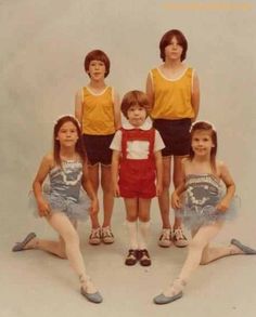 a group of young children standing next to each other in front of a white background