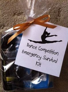 an emergency survival kit is wrapped in plastic and has a sign that says dance competition emergency survival kit