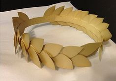 a paper wreath made out of cardboard with leaves