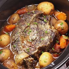 a pot roast with potatoes and carrots in the slow cooker, ready to be eaten