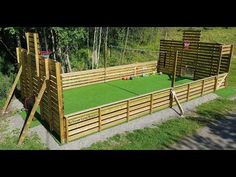 an outdoor play area made out of wood and artificial grass