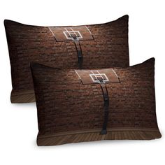 two pillow cases with basketball hoop on brick wall and wood flooring, one in the middle