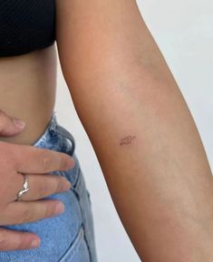 a close up of a person with a tattoo on their arm and the word love written in small cursive writing