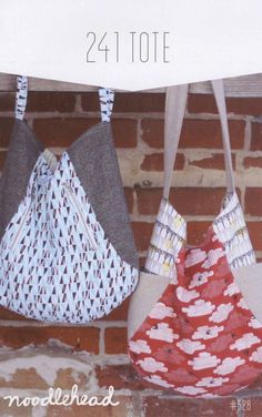 three purses hanging on a brick wall with the words noodlehead written below them