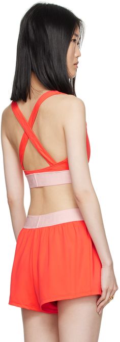 Stretch nylon jersey bikini top. · Scoop neck · Cutout at front · Jacquard logo at elasticized hem · Fixed shoulder straps · Criss-crossing straps at back · Partially lined Supplier color: Coral Sporty T-back Swimwear With Crisscross Straps, Summer Athletic Swimwear With Crisscross Straps, Summer Workout Swimwear With Crisscross Straps, Sporty Fitted Swimwear With Crisscross Straps, Adjustable Straps Strappy Back Sports Bra, Sporty Swimwear With Crisscross Straps For Summer, Fitted Sports Bra With Adjustable Crisscross Straps, Medium Support Sports Bra With Crisscross Straps, Sporty Swimwear With Cross Back And Built-in Bra