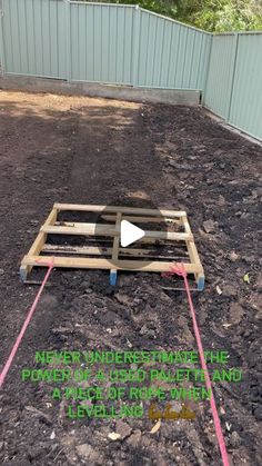 a wooden pallet sitting in the middle of a yard with text overlaying it