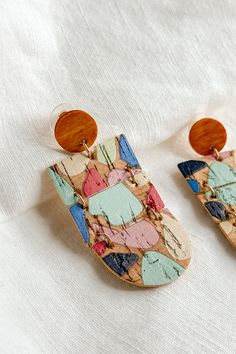 Close up view of the Wrenly Cork Multi Dangle Earring which features cork dangle earrings with multi color spots design Paint Cork, Cork Earrings, Cork Material, Jumpsuit Shorts Rompers, Hair Fragrance, Dress Jewelry, Diy Painting, Jewelry Sales, Set Dress