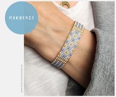 a woman's arm with a bracelet on it and the words makzence written