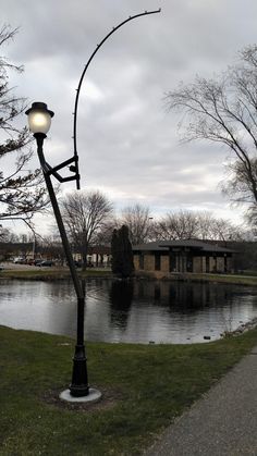 a lamp post next to a body of water