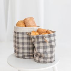 two bags filled with pastries sitting on top of a white table next to each other