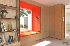 the interior of a modern home with orange painted walls and shelving units on either side