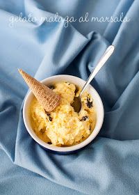 a bowl filled with ice cream on top of a blue blanket