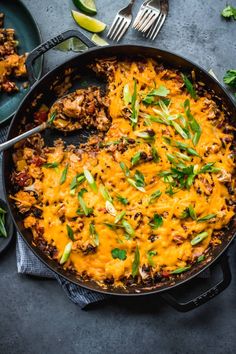 a skillet filled with mexican food and garnished with cilantro