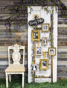 an old chair is sitting in front of a wooden wall with pictures and frames on it