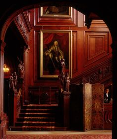 an archway leading to a room with paintings on the walls