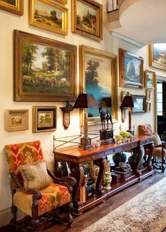 a living room filled with furniture and pictures on the wall