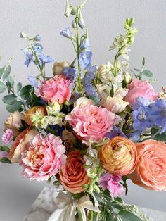 a vase filled with lots of different colored flowers