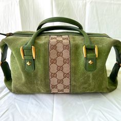 This Is An Authentic Gucci Suede Monogram Small Boston Bag In Green. This Chic And Very Rare Vintage Style Tote Is Finely Crafted Of Green Colored Suede With Dark Brown And Brown Gucci Gg Monogram Canvas Striping. The Handbag Features Rolled Leather Top Handles And Light Brass Hardware. The Top Zipper Opens To A Natural Fiber Interior With Zipper And Patch Pockets. Good Vintage Condition - The Item Has Been Used With Visible Signs Of Wear. There May Be Slight Patina And Other Indications Of Use. All Of Which Are Either Described In Detail Or Visually Declared In The Product Photos. Exterior: Corner Wear, Creases, Scuffs, Discoloration, Edge Wear, Pilling Handle: Surface Wear, Creases, Scuf Gg Monogram, Boston Bag, Product Photos, Brass Hardware, Leather Top, Monogram Canvas, Womens Tote Bags, Very Rare, Gucci Bag