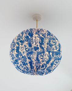 a blue and white lamp hanging from the ceiling