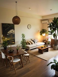 a living room filled with furniture and plants