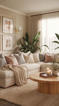 a living room filled with furniture next to a window covered in curtains and pillows on top of a rug