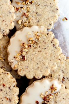 some cookies with icing and nuts on top