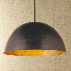 a brown and yellow light hanging from a ceiling fixture in a room with beige walls