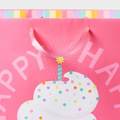 a pink birthday bag with a white frosted cupcake on it and the words happy birthday