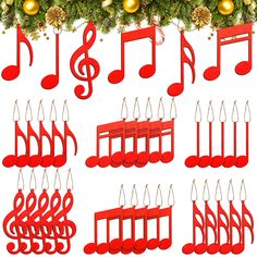 twelve red musical notes hanging from a christmas tree with ornaments around them and pine cones in the background