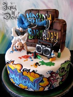 a birthday cake is decorated with graffiti and music equipment