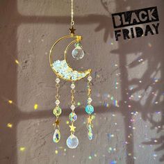 a sun catcher hanging from the side of a wall with a black friday sign in the background